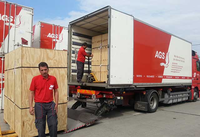 AGS Movers in Bucharest staff loading a moving truck.