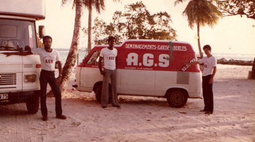 AGS Guadeloupe 3 men posing with movers trucks in the 70s